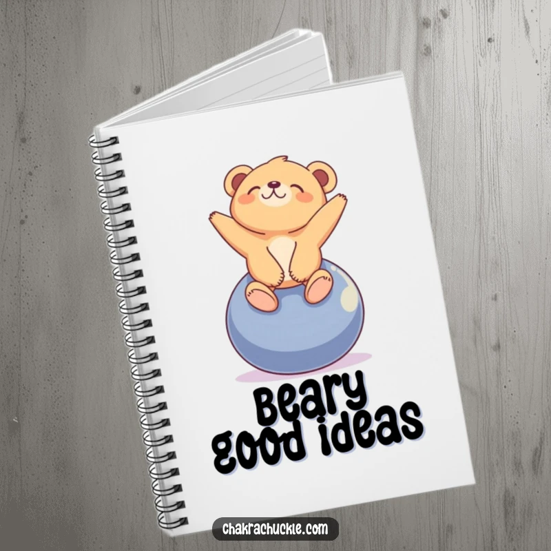 Funny tiny bear cub notebook with a cub blissfully balancing on a yoga ball, looking peacefully upwards.