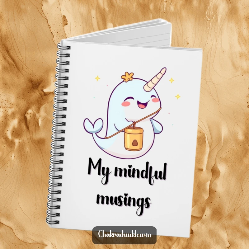Funny narwhal notebook joyfully blowing a meditation chime, ideal for peaceful and humorous note-taking.
