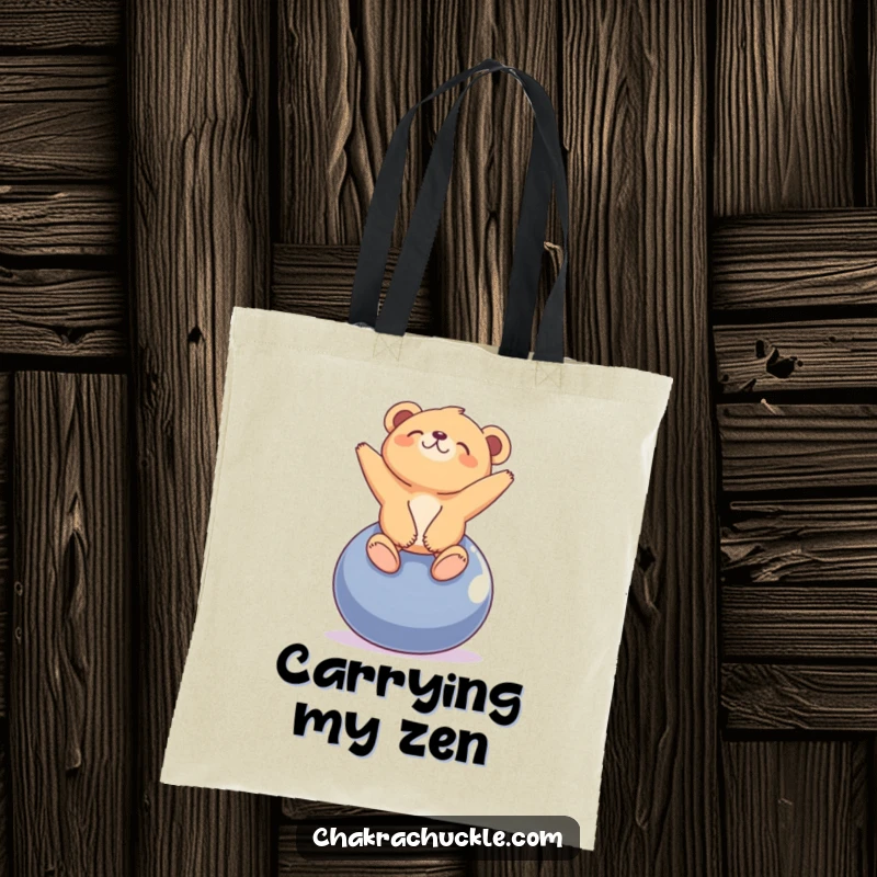 Funny tiny bear cub tote bag with a cub balancing on a yoga ball, looking blissfully upwards. Charming.